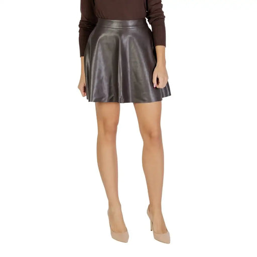 A sleek high-waisted mini skirt in shiny charcoal gray faux leather with a flared silhouette for fall winter