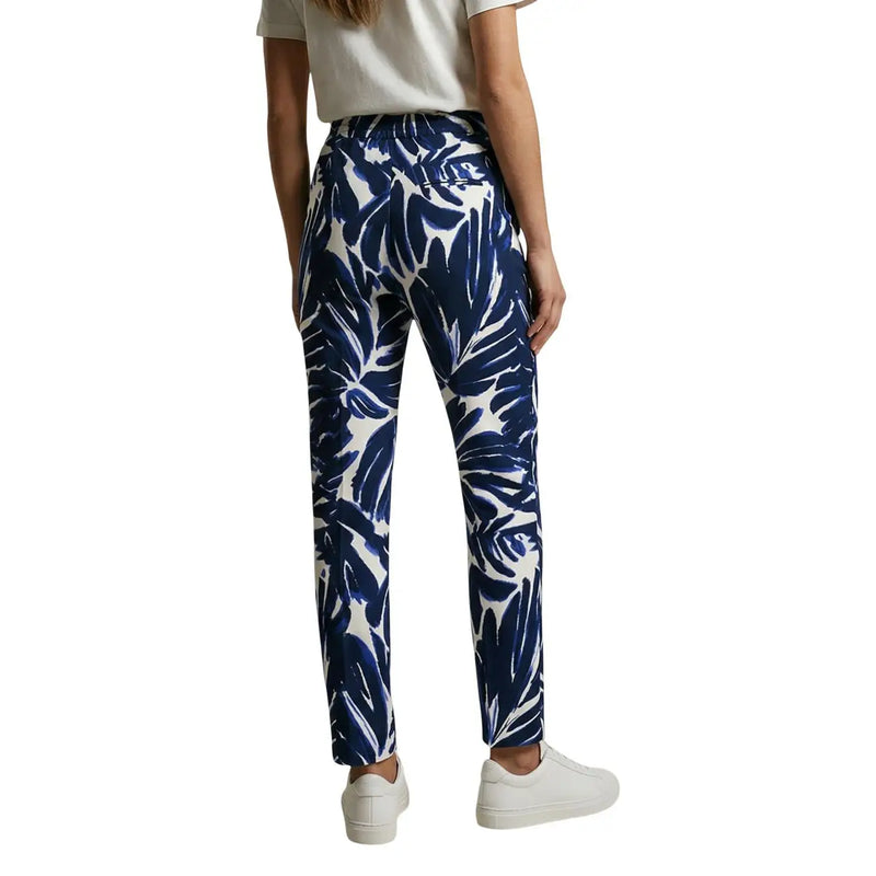 Only Pantalon en viscose bleue à fleurs pour femme, orné d'un motif de feuilles tropicales blanches et de poches avant, idéal pour une tenue décontractée.
