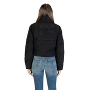 Woman from behind wearing black puffer jacket and blue jeans, showcasing Only Women Long Black Turtleneck Zip Jacket