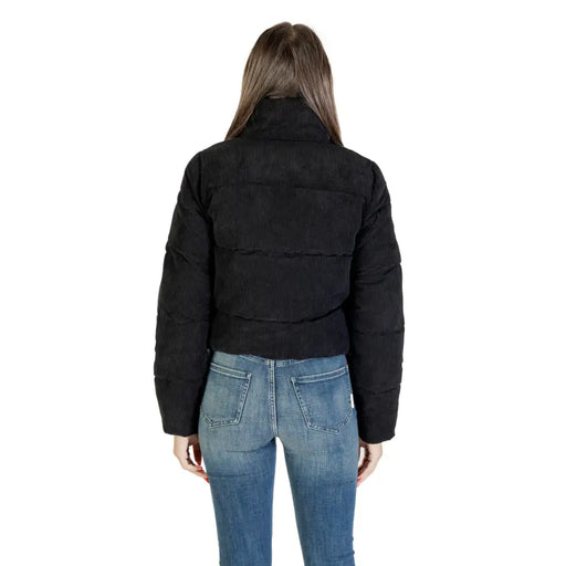 Woman from behind wearing black puffer jacket and blue jeans, showcasing Only Women Long Black Turtleneck Zip Jacket