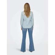 Light-wash denim flared pants with a classic tapered fit paired with an Only women long light blue cotton button shirt