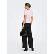 Black crocodile-embossed structured handbag with top handle and metallic hardware paired with pink round neck t shirt