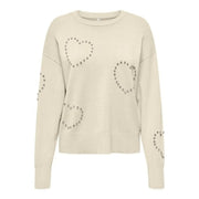 Pull en maille viscose couleur crème à col rond orné de clous argentés en forme de cœur et de cercle pour femme