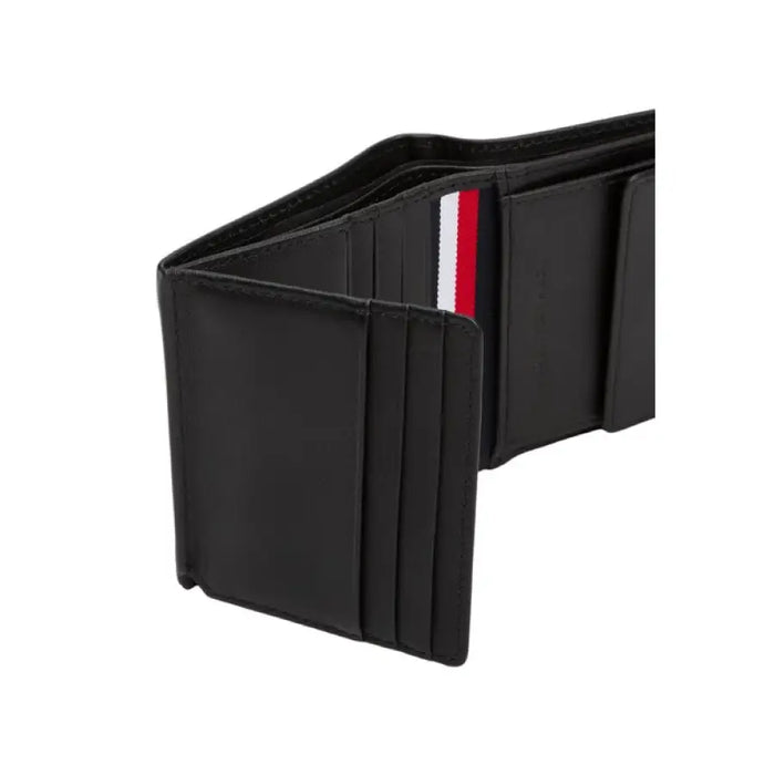 Open black leather wallet from Tommy Hilfiger with multiple card slots and cash compartment