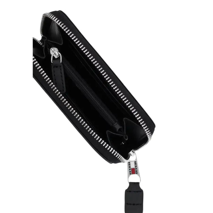 Open black zippered wallet from Tommy Jeans featuring multiple compartments and sleek design