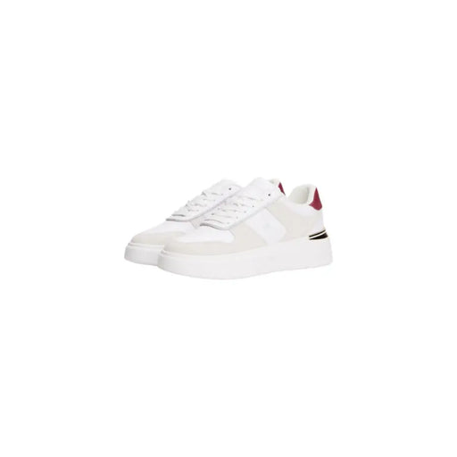 Pair of Tommy Hilfiger white leather women’s sneakers with burgundy heel accent and black stripe