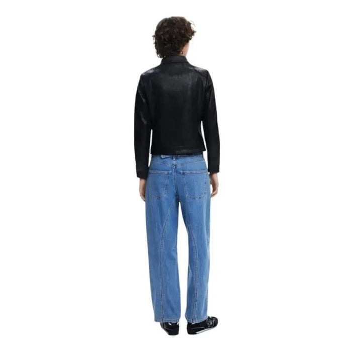 Person modeling Desigual Women’s Black Zip Jacket with Round Neck and blue jeans