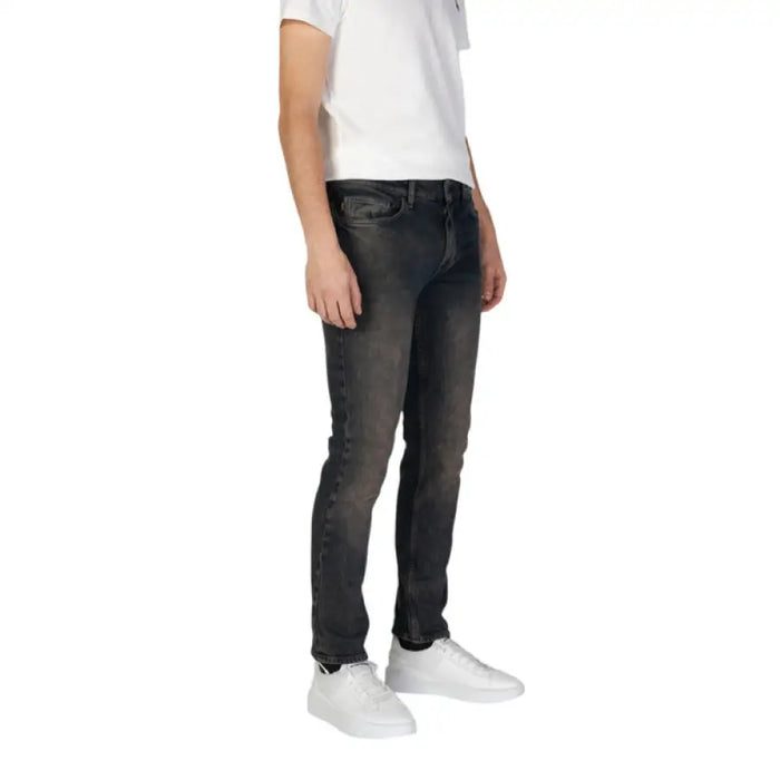 Person showcasing Boss Men Blue Jeans with Worn Out Effect, wearing gray jeans and white sneakers
