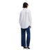 Person in a white shirt and navy pants showcasing Desigual Women’s Floral Cotton Shirt