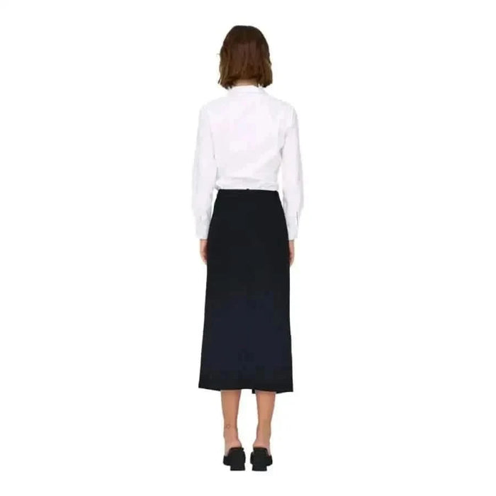 Person in a white long-sleeved top and black skirt from Jacqueline De Yong collection