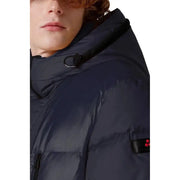 Navy blue down jacket with hood and red logo patch on sleeve.