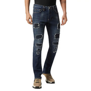 Jean Philipp Plein pour homme, bleu délavé, en coton, avec de multiples déchirures et un effet usé le long des jambes.