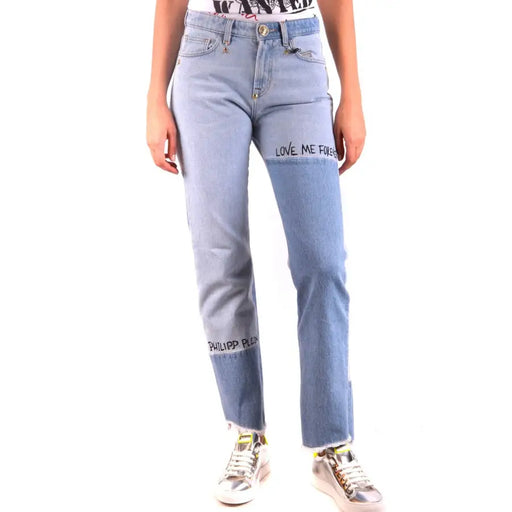 Women wearing Philipp Plein light blue and medium blue denim jeans with frayed hem and silver sneakers