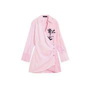 Pink striped cotton v-neck dress by Desigual with a pink and white striped wrap-style blouse and black floral embroidery