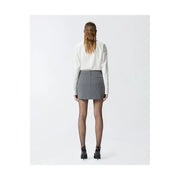 Pinko grey tailored mini skirt with structured waistband and front pockets worn with white blouse and black heels
