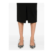 Black and white polka dot pointed-toe slingback pumps paired with Pinko women black viscose blend skirt