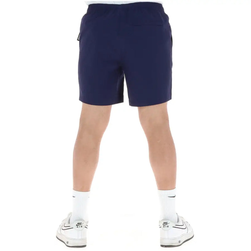 Short de sport Psycho Bunny pour homme, bleu marine, en polyester, avec taille élastiquée à cordon et poches latérales, idéal pour la baignade.