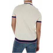 Polo homme beige à manches courtes en maille côtelée de coton, orné d'un motif lapin psycho crème et de finitions bleu marine et rose.