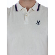 Cream-colored cotton psycho bunny men polo shirt with navy pink collar trim and black embroidered logo short sleeve