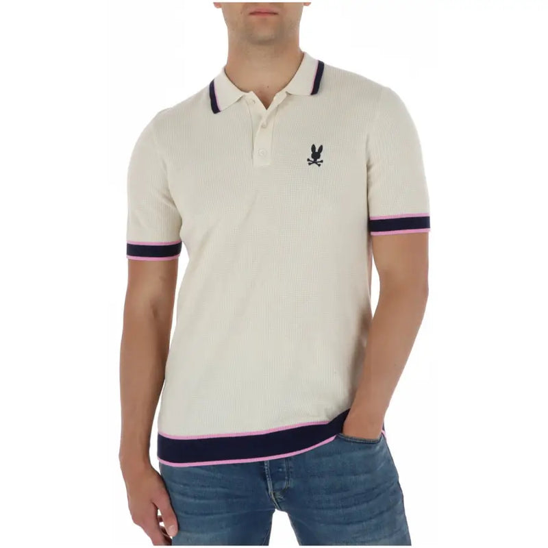 Polo homme Psycho Bunny couleur crème côtelé, avec finitions bleu marine et roses et logo lapin brodé noir en coton