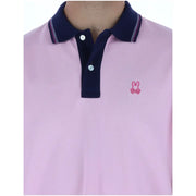 Polo homme Psycho Bunny rose à manches courtes en coton avec col bleu marine et petit logo lapin rose brodé