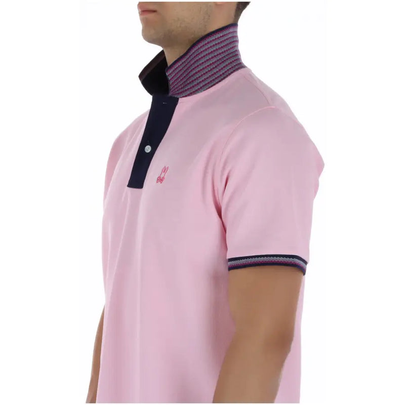 Polo homme Psycho Bunny rose à manches courtes en coton avec détails bleu marine et rayures discrètes au col et aux poignets.
