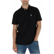 Polo Psycho Bunny pour homme, manches courtes, en coton noir, avec logo lapin et crâne brodés en blanc sur la poitrine gauche.