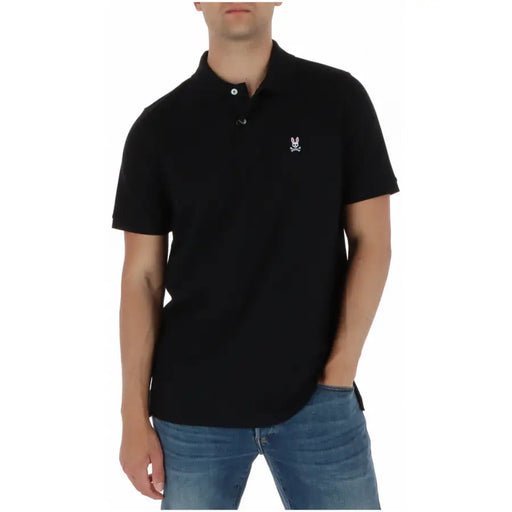 Polo Psycho Bunny pour homme, manches courtes, en coton noir, avec logo lapin et crâne brodés en blanc sur la poitrine gauche.