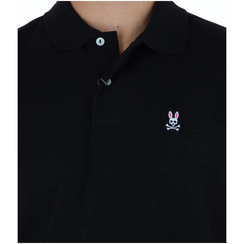 Psycho Bunny men polo short sleeve black cotton shirt with white embroidered rabbit skull logo on the chest