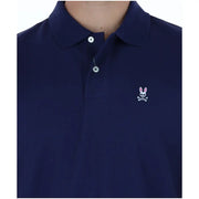 Polo homme Psycho Bunny en coton bleu marine à manches courtes, orné d'un logo brodé blanc représentant un lapin en tête de mort et des os croisés sur la poitrine.