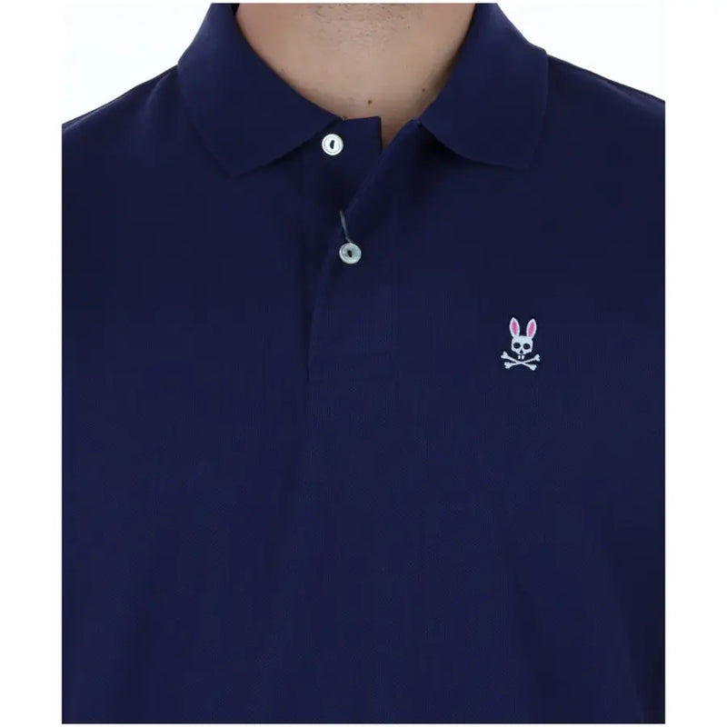 Polo homme Psycho Bunny en coton bleu marine à manches courtes, orné d'un logo brodé blanc représentant un lapin en tête de mort et des os croisés sur la poitrine.