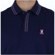 Navy blue Psycho Bunny men polo short sleeve cotton shirt with white double-stitching and pink embroidered logo