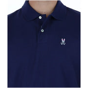 Polo Psycho Bunny pour homme, bleu marine, orné d'un logo brodé blanc représentant un crâne de lapin et des os croisés (vue de face).