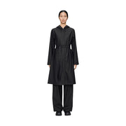 Black hooded trench coat with belted waist and long sleeves made of polyester for women by Rains