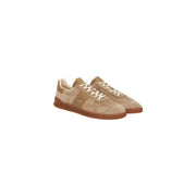 Beige suede sneakers with white laces and gum soles.