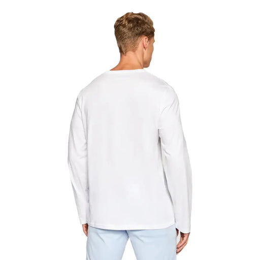 Men’s white long-sleeve cotton T-shirt paired with light blue pants from Ralph Lauren