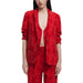 Red floral patterned blazer suit displayed on a mannequin for stylish formal wear