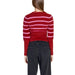 Red and pink striped Women’s Round Neck Sweater paired with dark jeans