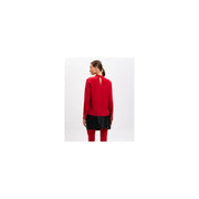 Red silk viscose twinset blouse with round neck and buttoned cuffs paired with black mini skirt and red leggings
