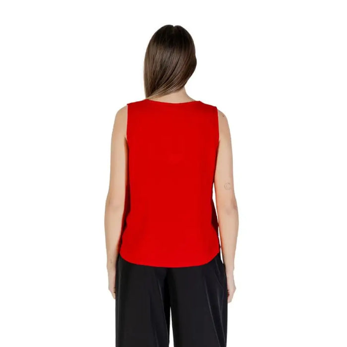 Red sleeveless V neck blouse displayed in a clothing product image