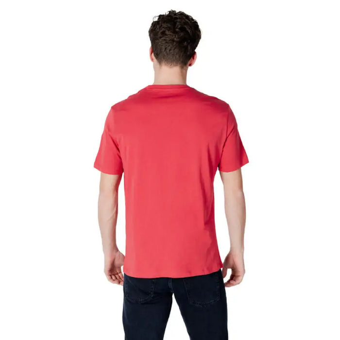 Man wearing Armani Exchange Men’s Red Print Slip On T-Shirt showcasing vibrant style