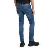 Blue denim jeans with a slim fit and black leather boots.