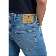 Jean homme Replay en denim bleu clair avec écusson de marque en cuir beige et surpiqûres dorées sur la poche (face arrière).