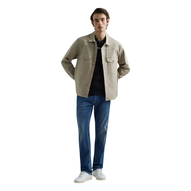 Beige utility-style jacket with button closures and two chest pockets paired with replay men straight leg blue stretch denim jeans