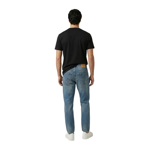 Replay men t-shirt paired with light-wash denim jeans featuring a classic five-pocket design and leather patch on back waistband