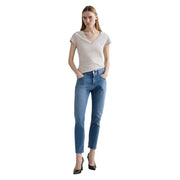 Un jean slim en coton bleu pour femme, de la marque Replay, avec une coupe droite et un ourlet court, dans un style denim classique.