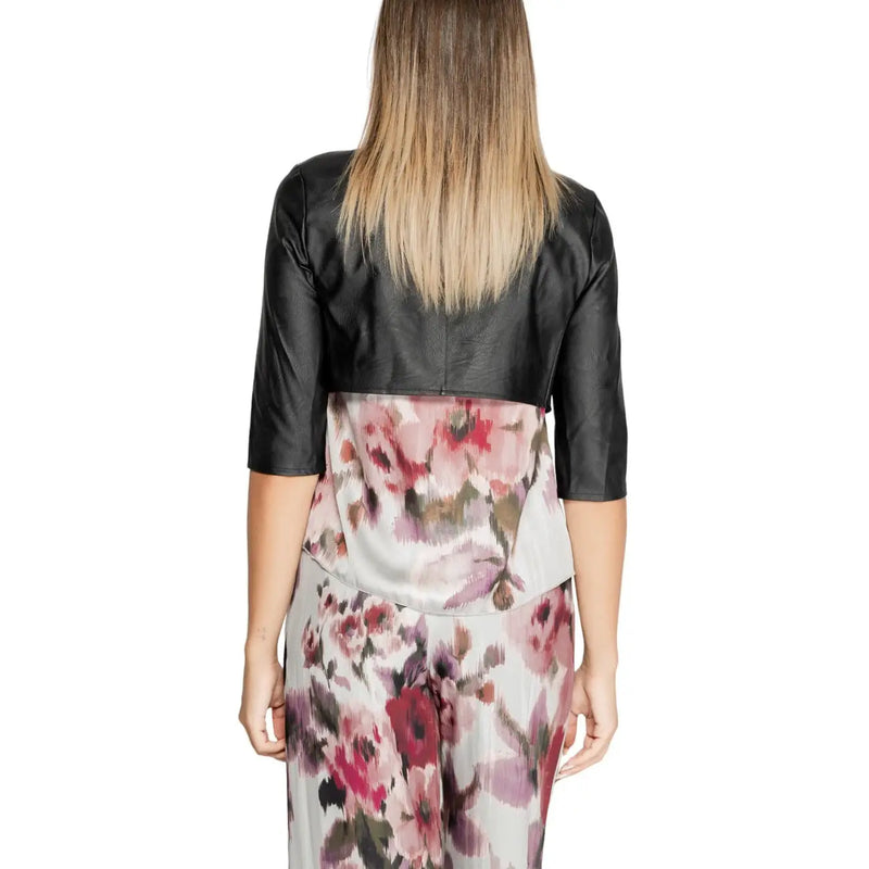 Rinascimento women black polyurethane cropped bolero jacket with three quarter sleeves worn over floral dress