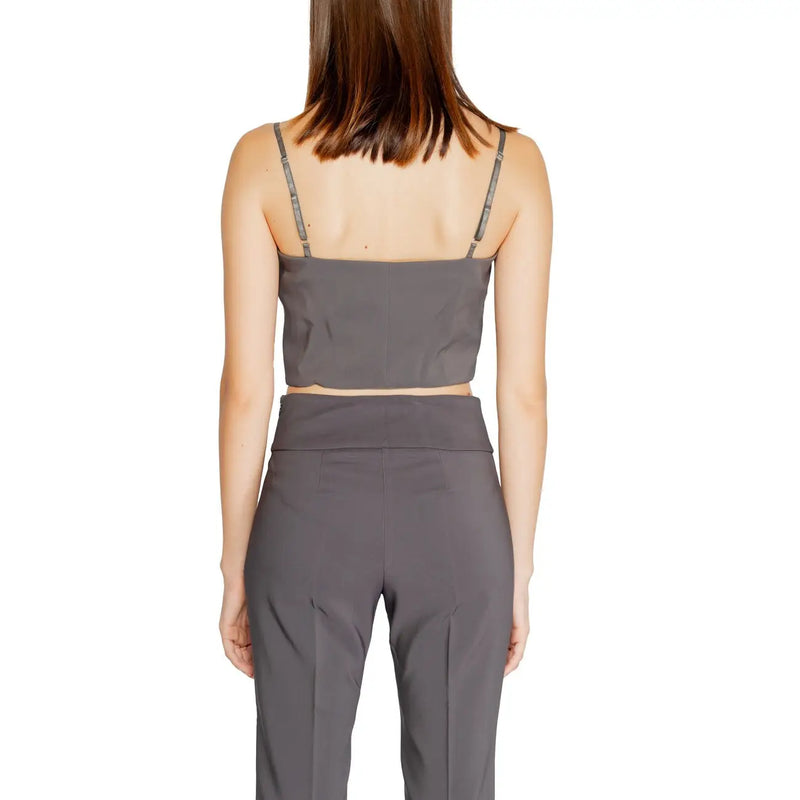 Un gris foncé élégant Rinascimento femmes tank top avec des fines bretelles et un décolleté en cœur, associé à un pantalon taille haute