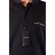 Polo Saint Laurent en coton noir pour homme, orné d'une broderie « Sweet Dreams » en fil d'or, vue de face