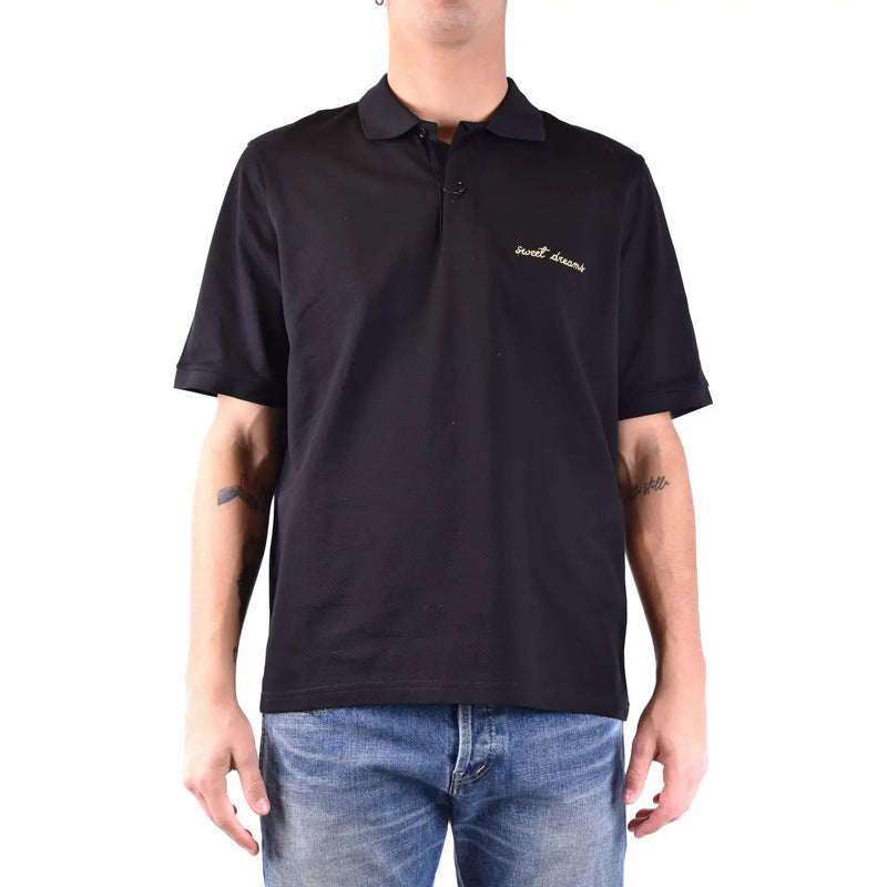 Polo Saint Laurent en coton noir pour homme, orné d'une broderie dorée « Sweet Dreams » sur la poitrine gauche, vue de face